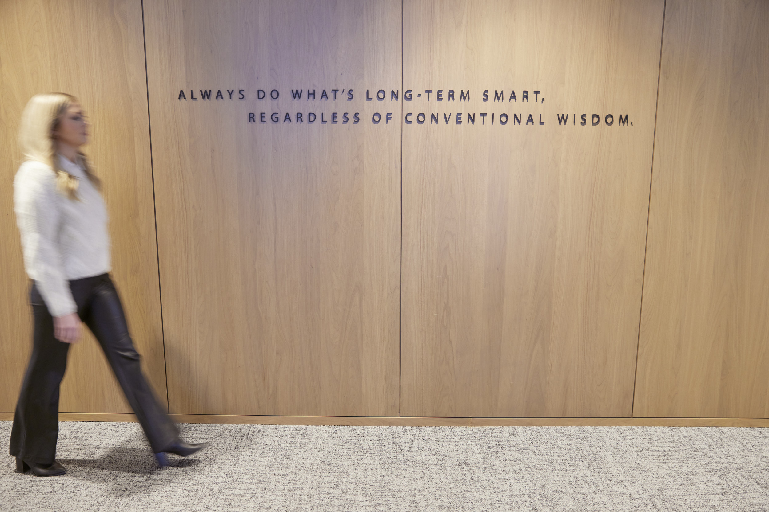 Woman Walking Down Hallway with Quote