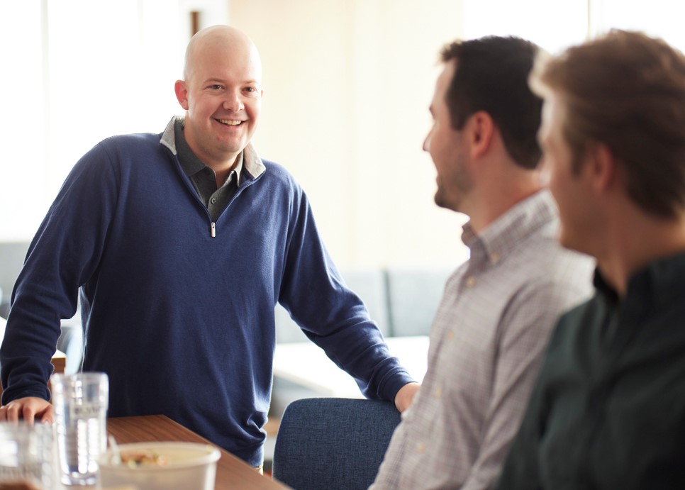 three men in conversation